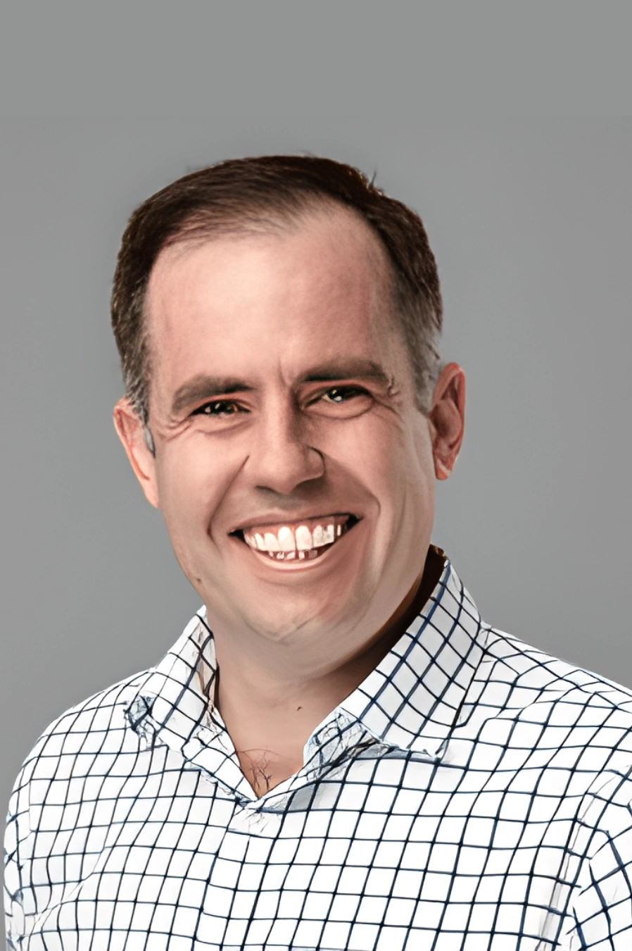 A man smiling and showing his teeth