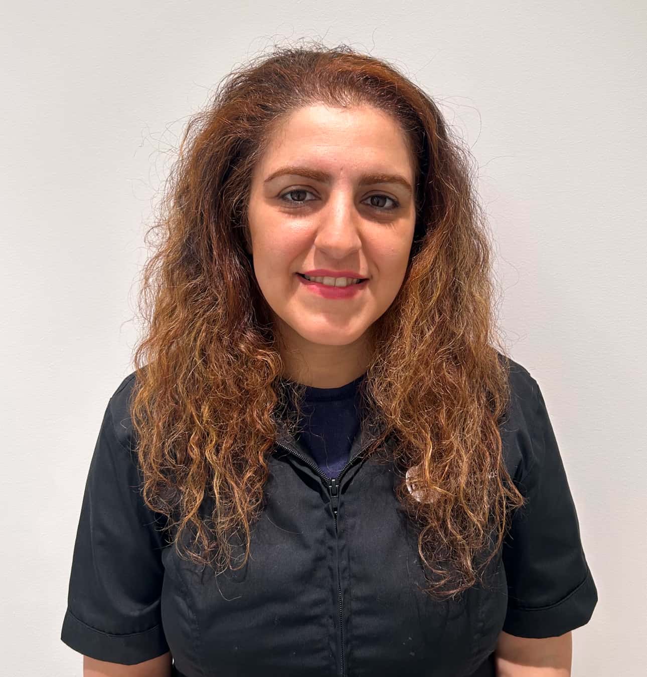 Woman with curly hair in black shirt